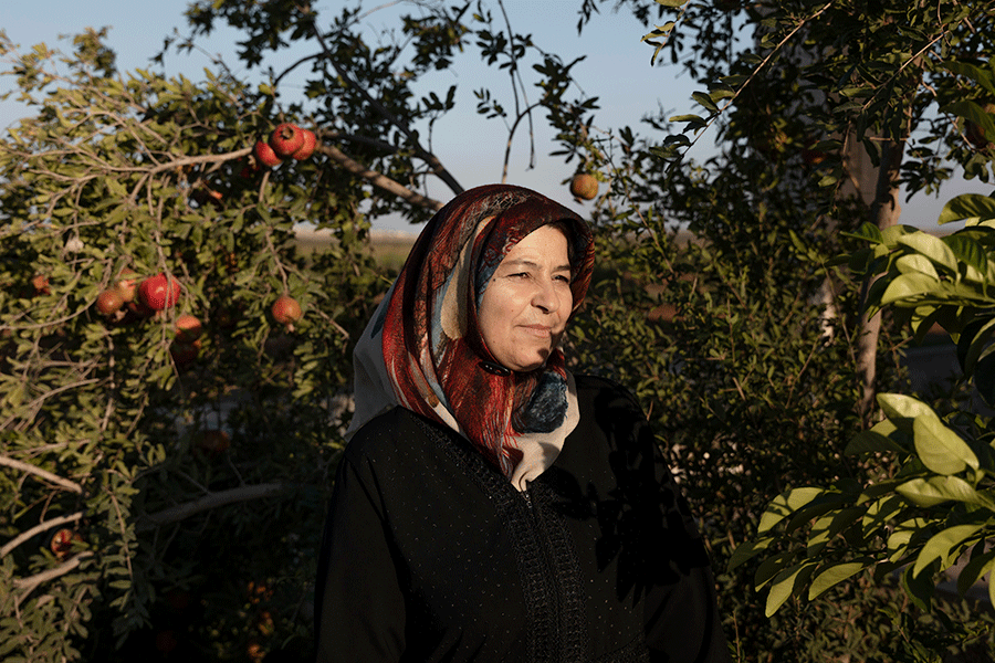 Hala Mahmoud Almahmoud outside her family’s house near Ltamenah, Syria, Sept. 10, 2025. She received $500 in cryptocurrency to help restart her farm. (Emile Ducke/The New York Times)