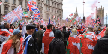 Tommy Robinson's rally sold merch, streamed ads, and promoted a crypto coin — that's the point