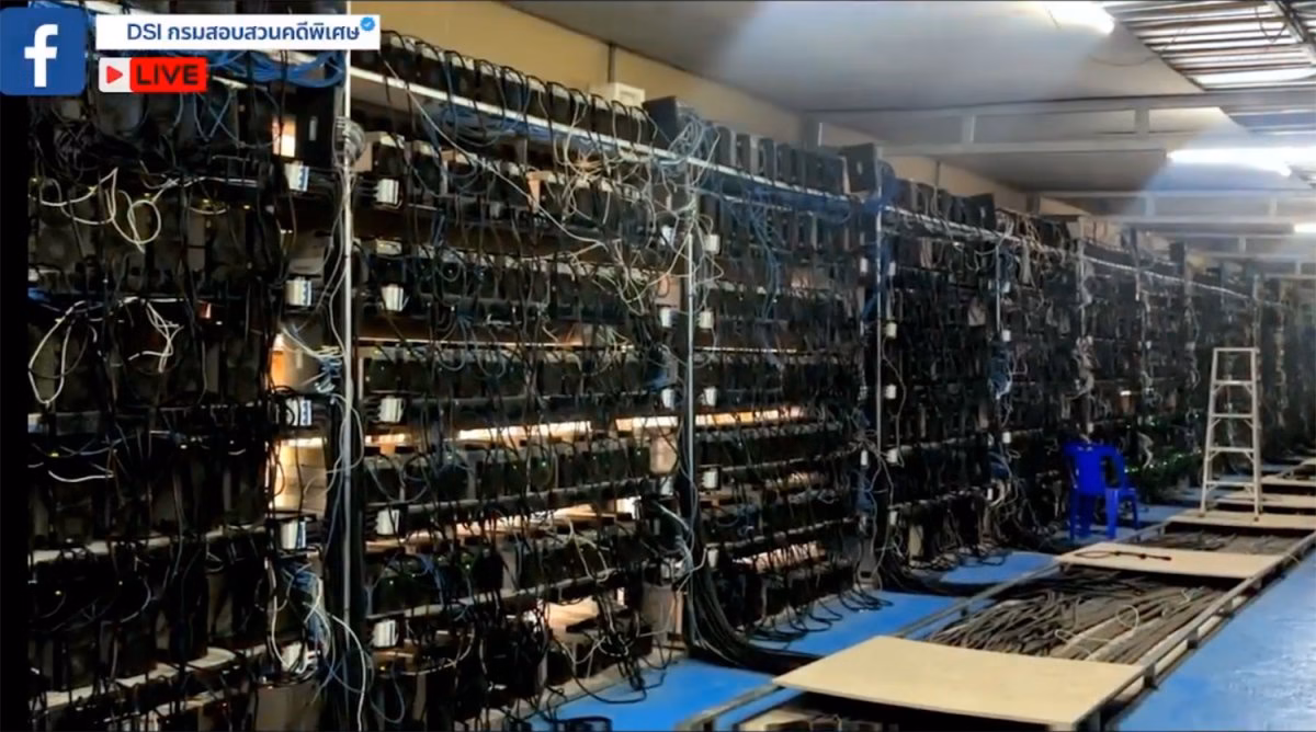 Racks filled with cryptocurrency mining machines are seen inside one of two warehouses in Samut Sakhon found to have illegally tapped electricity to power a bitcoin mining operation. (Screenshots from DSI Facebook page)